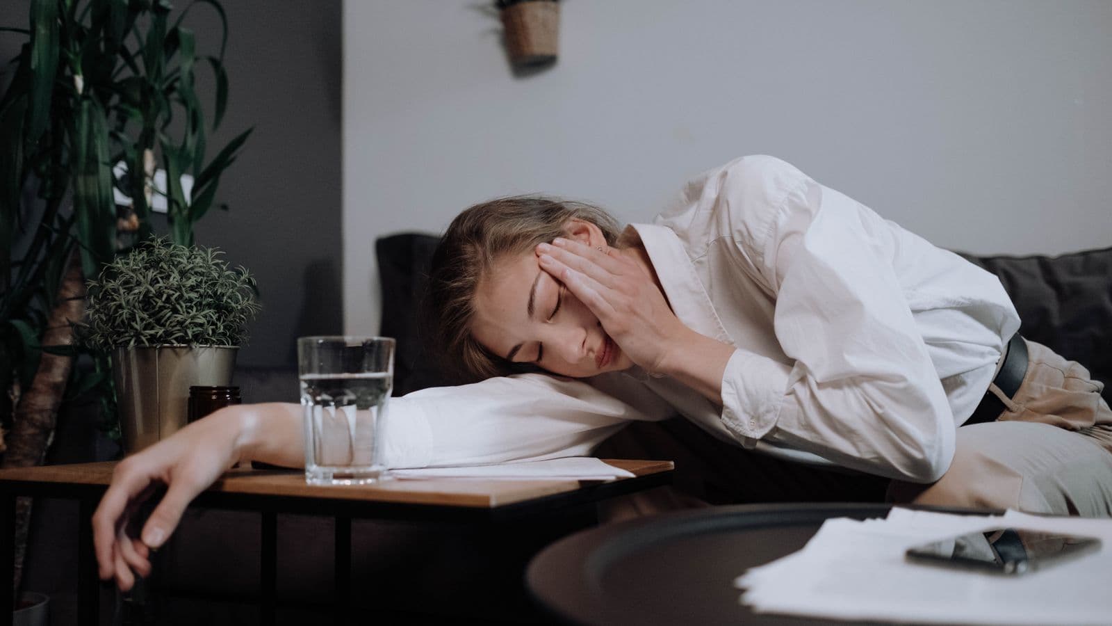 A tired person resting at their desk