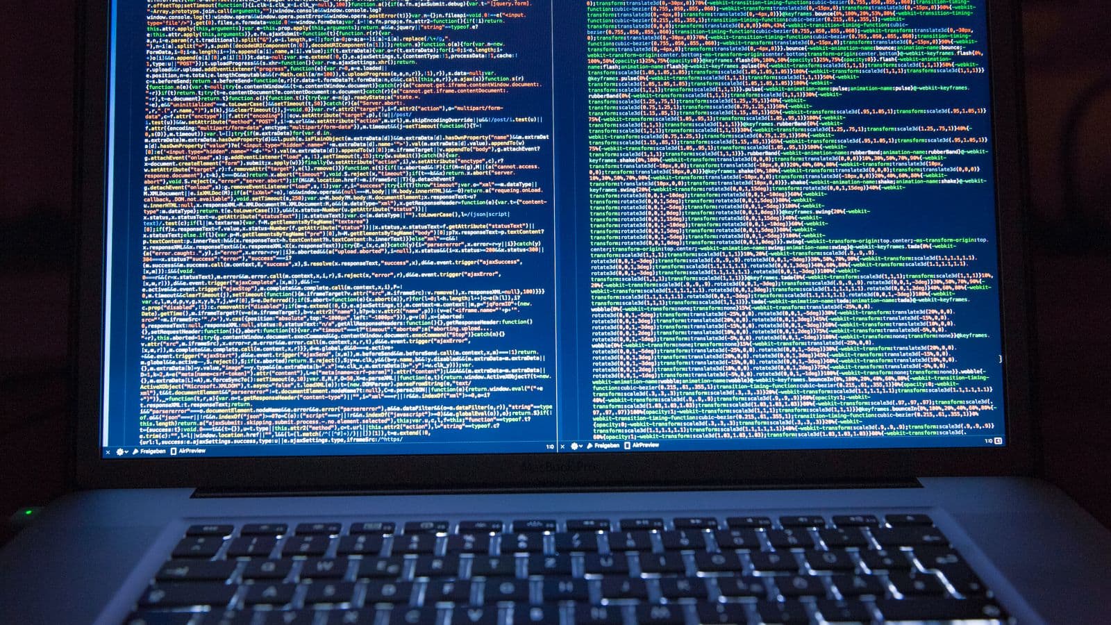 Code on a laptop screen in a dim room